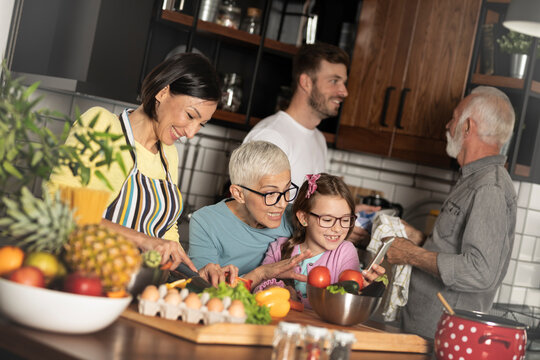 Happy extended family enjoying during prepare lunch in the kitchen