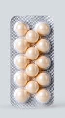 Round Tablets in Pharmaceutical Blister Pack Close-up of a blister pack containing soft gel capsules in a light background.