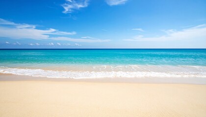 Serene beach scene with golden sand meeting turquoise water under a bright, clear sky