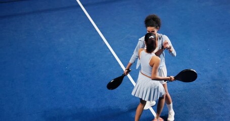 Above, high five and padel with women at venue for competition, point scoring or tournament. Sports, fitness and motivation with friends on tennis court together for success, victory or winning - Powered by Adobe