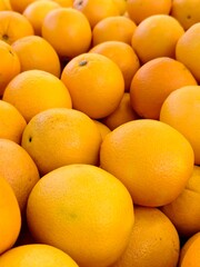 A close-up of many oranges, a perfect display of freshness.