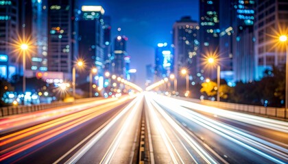 Fototapeta premium Cityscape at night. Car light trails blur across a bridge lined with bright streetlights and tall buildings