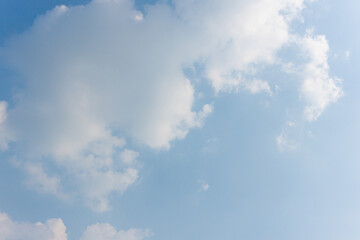 Cumulus clouds floating in a blue sky on a sunny day