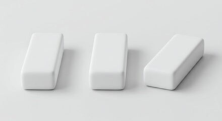Minimalist composition of three white rectangular erasers on a clean surface, symbolizing correction, simplicity, and a fresh start.