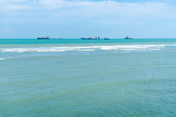 Vibrant blue ocean with striking rocky outcrops under a clear daytime sky in Tuban, Indonesia.