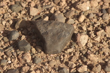 A close up of a black stone on the ground
