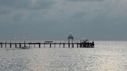 Morning view of the beach at Rameswaram, Tamil Nadu, India with sea bridge and fishing boats
