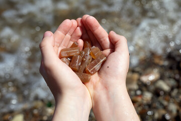 Fossilized belemnites in the palms of a child