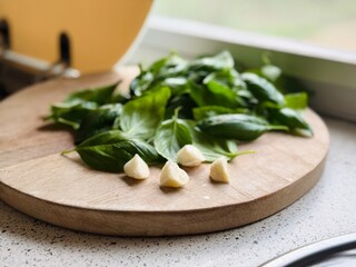 Fresh Basil and Garlic on Wooden Board Ready for Pesto – Organic Ingredients for Cooking.
