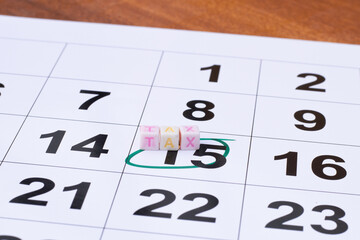 Number 15 marked in the green color marker with TAX buttons on top of the 15