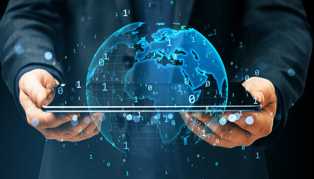 Businessman holding tablet with glowing digital world map, binary code and global network interface on dark background, symbolizing cyberspace data flow.