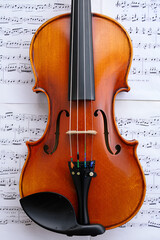 Fototapeta premium Violin on sheet music. Close up. Top view.
