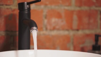 Water tap. Water tap in the kitchen. Slow motion. High quality 4K footage.