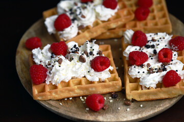 Homemade waffles with cream and raspberries