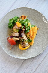 Colorful grilled chicken skewer with vibrant vegetables as a delicious food background. 