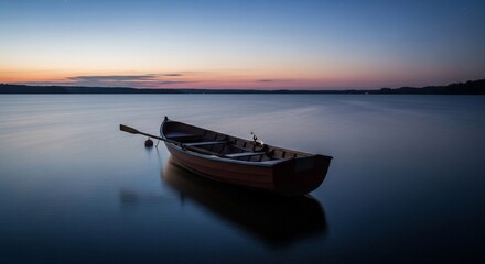 Naklejka premium Rowboat at Dusk: A Serene Lakeside Scene at Twilight with Calm Water