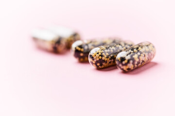 Iron capsules on bright background. Soft focus. Close up. Copy space.	