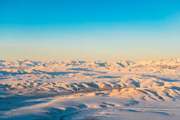 Woman Looking Out Airplane Window at Snowy Andes Mountains in Patagonia Argentina