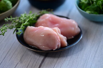 raw chicken breast with herbs