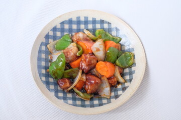Sweet and sour pork with carrot, green pepper, onion