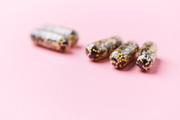 Iron capsules on bright background. Soft focus. Close up. Copy space.	