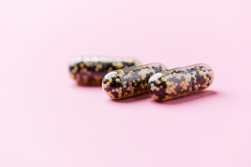 Iron capsules on bright background. Soft focus. Close up. Copy space.	