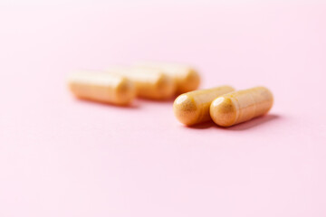 Vitamin B complex capsules on bright paper background. Soft focus. Close up. Copy space.	