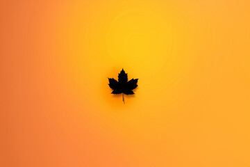 Fototapeta premium Black Maple Leaf Silhouette Centered on Warm Orange‑Amber Autumn Gradient