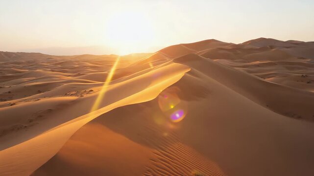 Majestic desert landscape with golden sand dunes glowing under a spectacular sunrise or sunset.