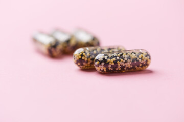 Iron capsules on bright background. Soft focus. Close up. Copy space.	