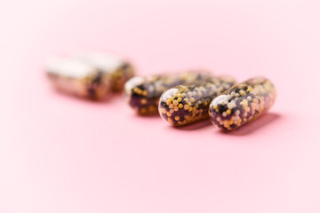 Iron capsules on bright background. Soft focus. Close up. Copy space.	