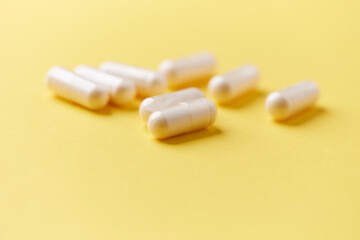 Collagen capsules. Bright paper background. Soft focus. Close up. Copy space.	