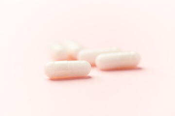Carnitine capsules. Concept for a healthy dietary supplementation. Bright paper background. Soft focus. Close up.	