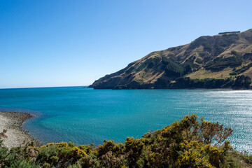 Serene Coastal Landscape with Blue Ocean and Green Hills