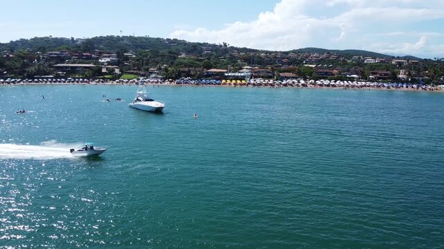 Boat Racing Across Ferradura Beach, B&uacute;zios, Brazil: A 2.7K Drone View of Tropical Seaside Fun and Ocean Adventure