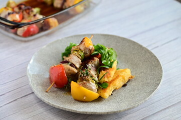 Chicken skewers with savory sauce in a glass baking dish, fresh from the oven. A delicious homemade meal scene showcasing rustic cooking and comfort food in a cozy kitchen setting.