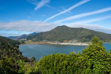 Scenic Bay View with Mountains and Lush Greenery