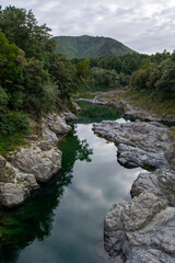 Serene River Landscape with Rocks and Greenery