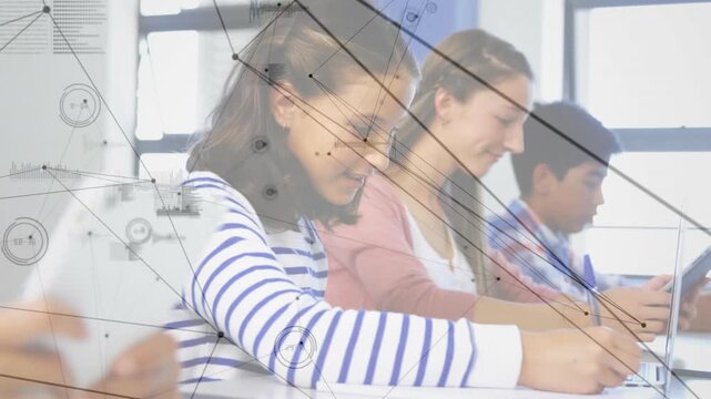 Students tapping devices while writing notes in classroom initiating network graphics linking peers