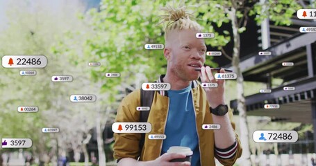Male commuter with coffee speaking into smartphone on path causing rising alert icons for tech demo - Powered by Adobe