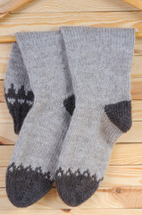Woolen socks on a wooden background. Knitted clothes.