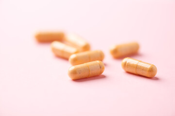 Vitamin B complex capsules on bright paper background. Soft focus. Close up. Copy space.	
