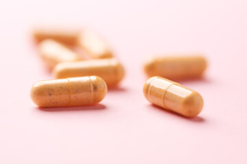 Vitamin B complex capsules on bright paper background. Soft focus. Close up. Copy space.	