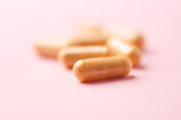 Vitamin B complex capsules on bright paper background. Soft focus. Close up. Copy space.	