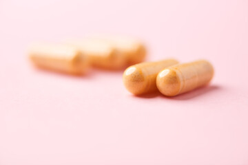 Vitamin B complex capsules on bright paper background. Soft focus. Close up. Copy space.	