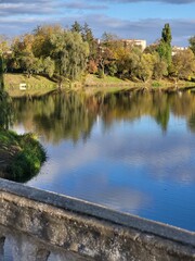 Reflection of a lake in a woody autumn forest