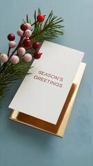 Elegant Christmas and Holiday Card Mockup with Pine Branch and Berries on a Light Blue Background with Sunlight