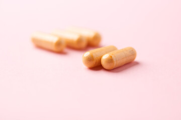 Vitamin B complex capsules on bright paper background. Soft focus. Close up. Copy space.