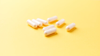 Collagen capsules. Bright paper background. Soft focus. Close up. Copy space.	