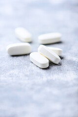 Amino acids tablets on wooden background. Soft focus. Close up	
